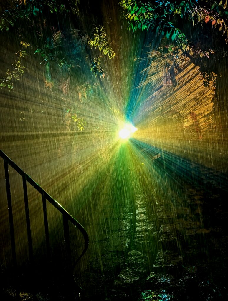 Un faisceau de projecteur en contre sous la pluie.